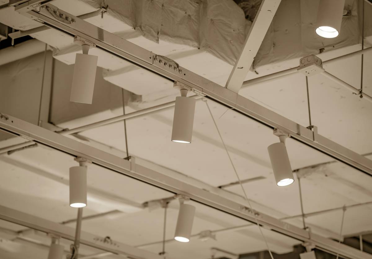 Modern retail store light fixtures illuminating clothing displays with high CRI LED spotlights