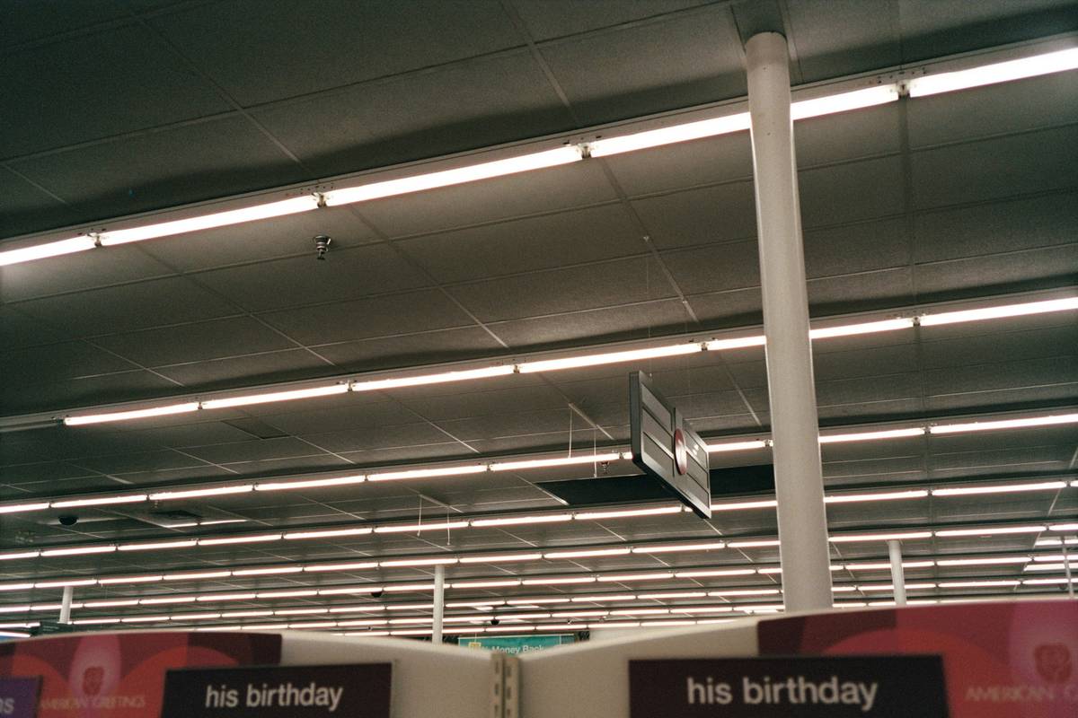 Comparison of retail store light fixtures showing before and after lighting upgrade in a boutique