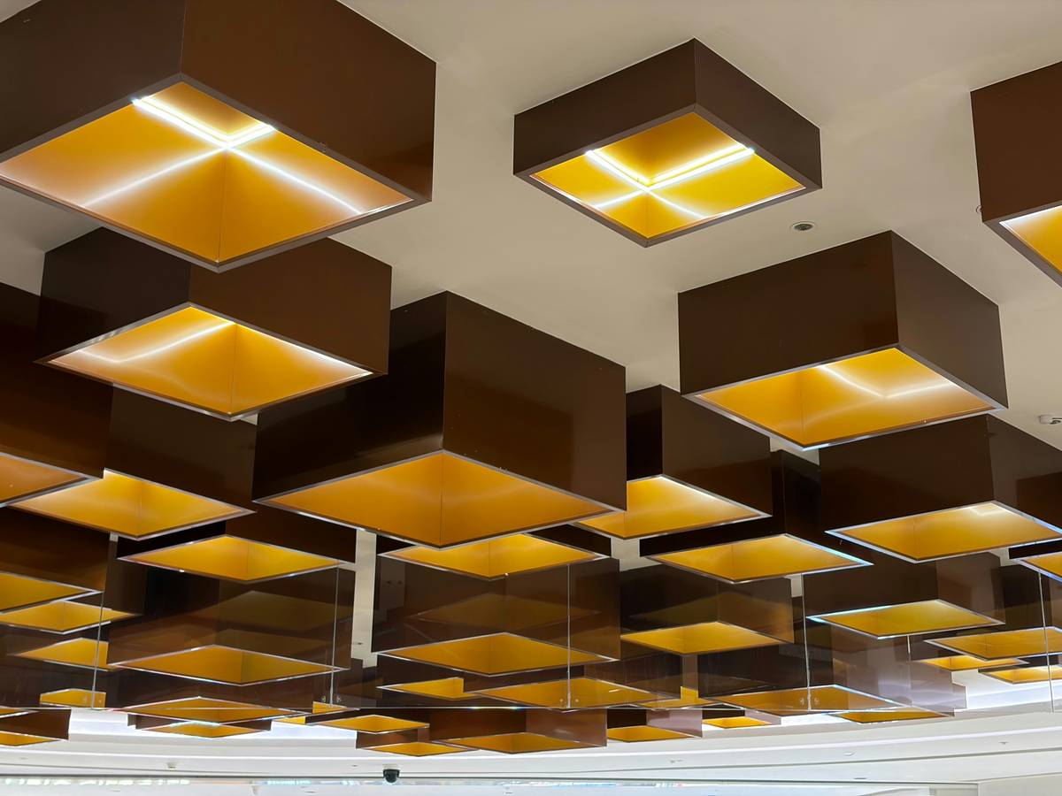Retail fixtures and supplies arranged in a well-lit commercial showroom with layered ambient and accent lighting
